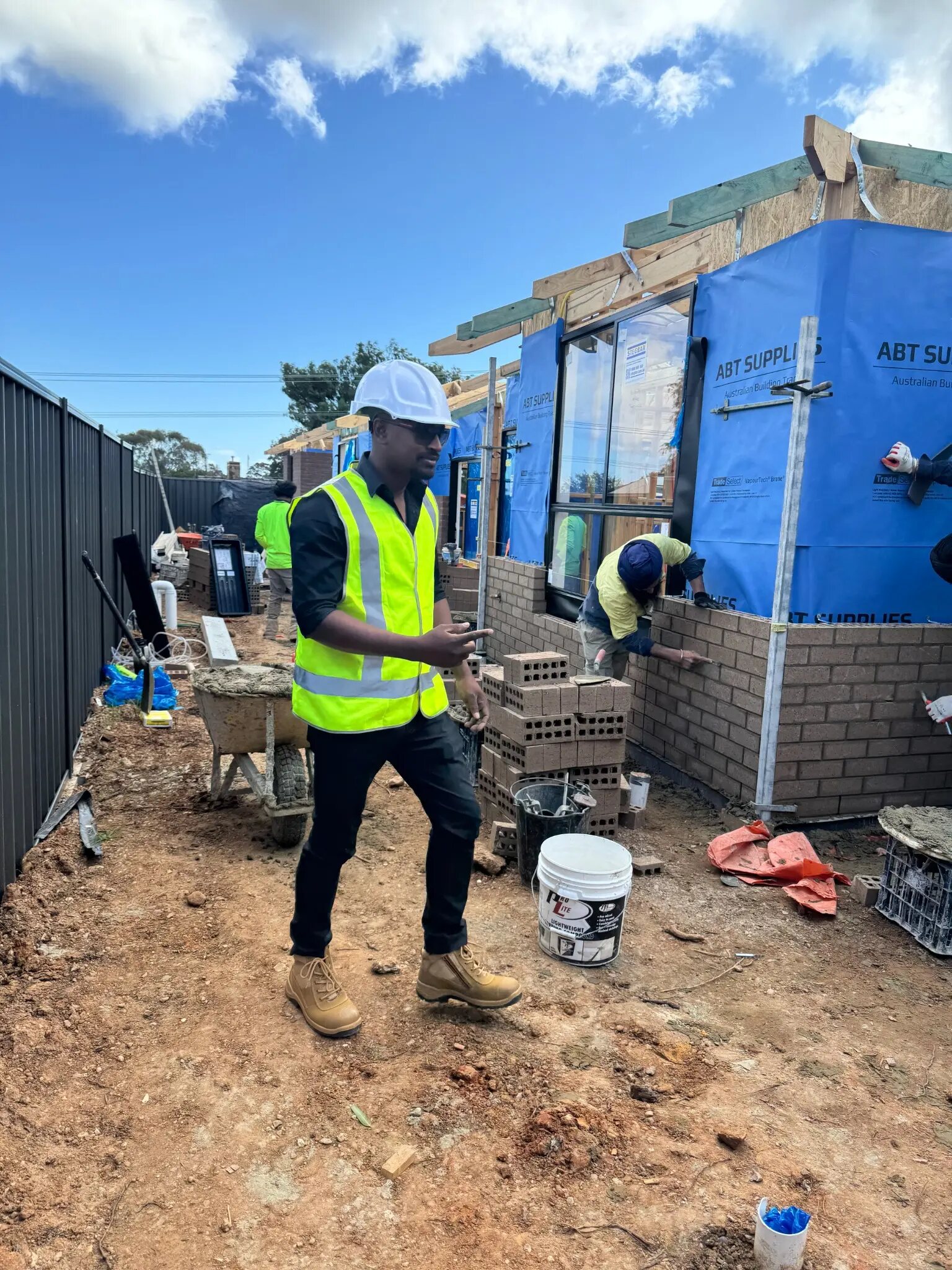 Imon Hussain supervising brickwork on an active residential building site