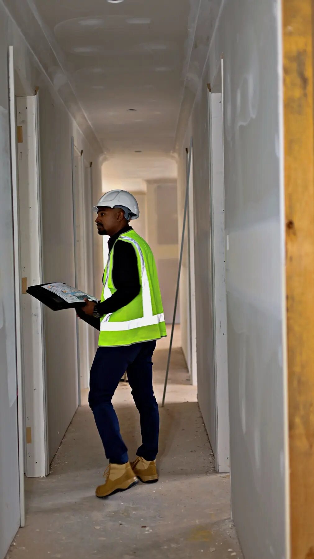 Imon Hussain conducting a quality walkthrough in a newly lined hallway